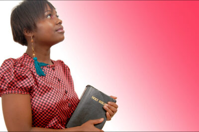 woman holding bible looking up