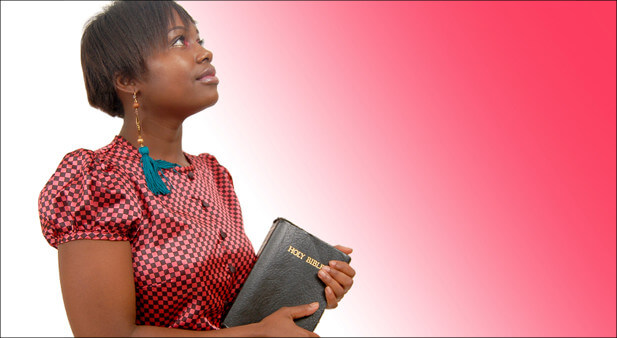 woman holding bible looking up