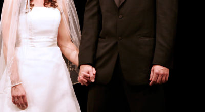 bride and groom holding hands