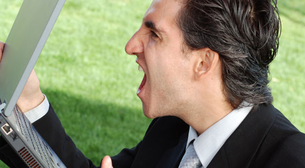 man yelling at computer