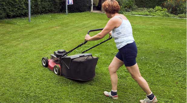 woman mowing lawn