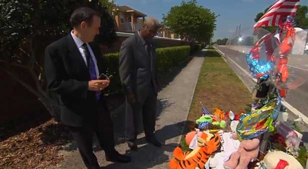 Me (l) and Dr. Raleigh Washington look over a memorial to Trayvon Martin