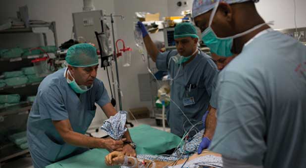 A Syrian man is carried to a surgery room in the Israeli city of Safed.