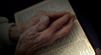 Praying hands on Bible