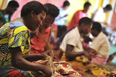 African woman making baskets