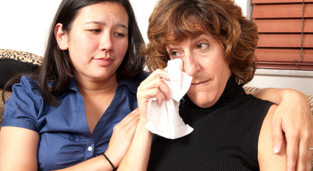 a woman comforting a friend