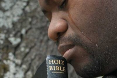 man in tears with Bible