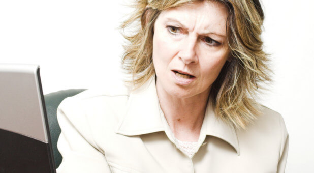 stressed woman looking at laptop