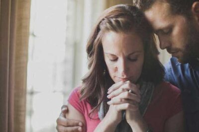 Husband and wife praying together