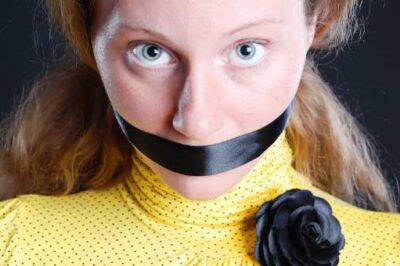 woman with mouth taped shut