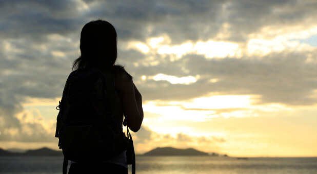 woman looking at sunrise