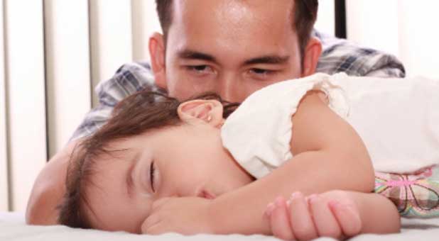 dad watching baby sleep