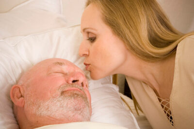 woman kissing man in hospital