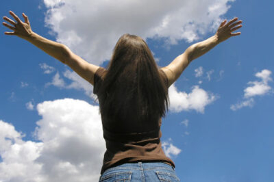 woman hands raised to the sky
