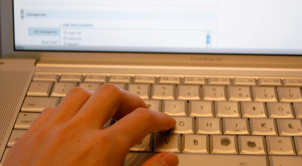 woman typing on laptop