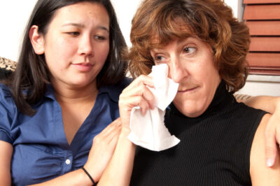 woman comforting crying woman