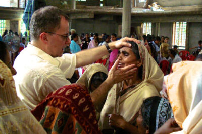 Lee Grady, founder of The Mordecai Project, ministers a group of women in India.