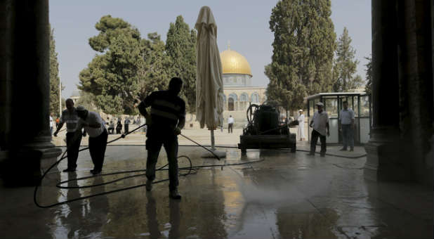Palestinians clean up after a disturbance at the Al Aqsa mosque.