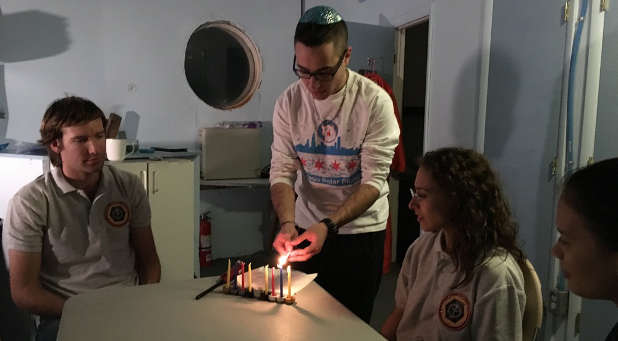 Barak Stoltz lights Hanukkah candles in the Mars Desert Research Station.