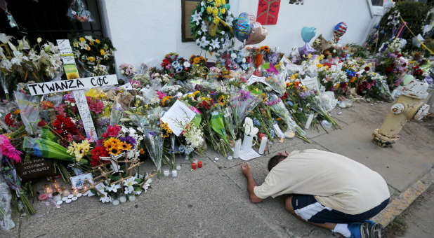 A man mourns at the memorial spot set up for the victims of the Emanuel AME Church shooting.