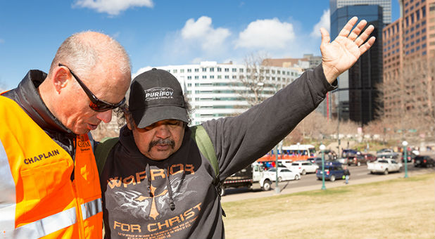 Attendees pray at the Decision America stop in Denver.