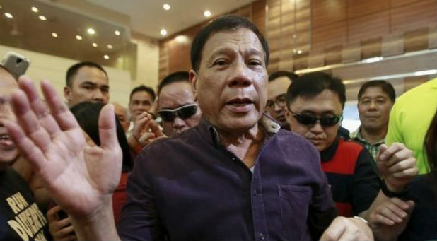 Rodrigo Duterte (C), a seven-term Philippine mayor, walks with his supporters during proclamation ceremony as a presidential candidate