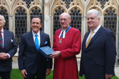 The Dean of Windsor David Conner accepts the special Bible for Queen Elizabeth II from Charisma Media CEO Steve Strang, miiddle left, at Windsor Castle in England on May 8. At left is British Col. David Waddell (Ret.) and on the far right is English businessman Martin Clarke.