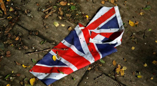 A British flag which was washed away by heavy rains the day before lies on the street in London, Britain, June 24, 2016 after Britain voted to leave the European Union in the EU BREXIT referendum.