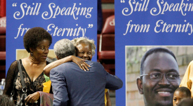 People greet the Rev. Anthony Thompson, husband of victim Myra Thompson before a memorial ceremony marking the first anniversary of the shootings at Emanuel AME Church during a prayer service where nine people were killed by a gunman, in Charleston, South Carolina
