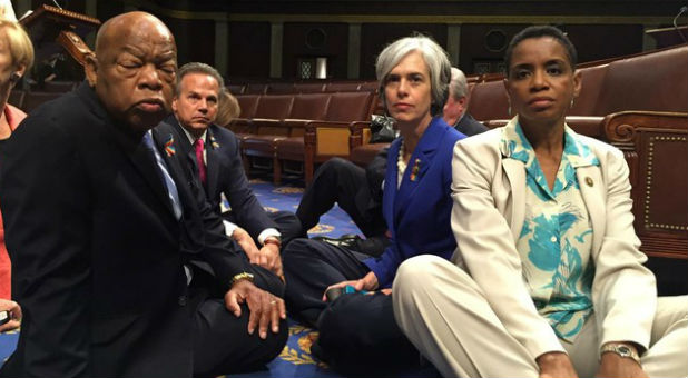 A photo tweeted from the floor of the U.S. House by Rep. Donna Edwards (R) shows Democratic members of the U.S. House of Representatives, including herself and Rep. John Lewis (L) staging a sit-in on the House floor