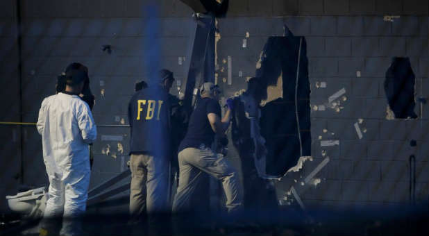 Police forensic investigators work at the crime scene of a mass shooting at the Pulse gay night club in Orlando, Florida.