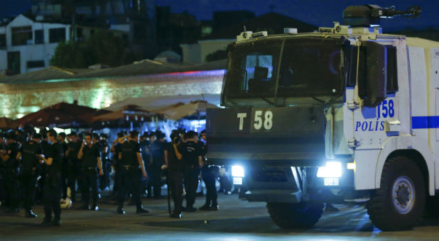 Turkish police officers stand by a car near the Taksim Square in Istanbul, Turkey.