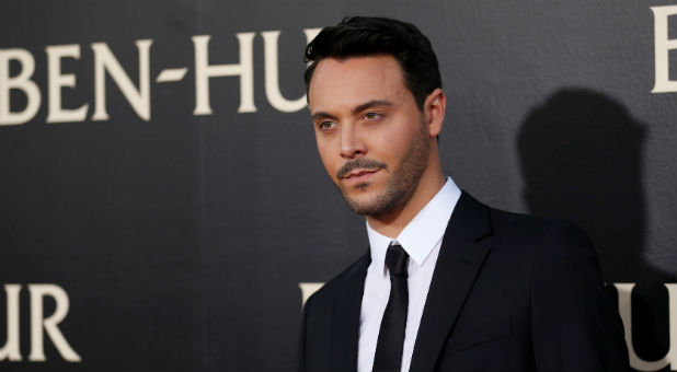 Cast member Huston poses at the premiere for the movie