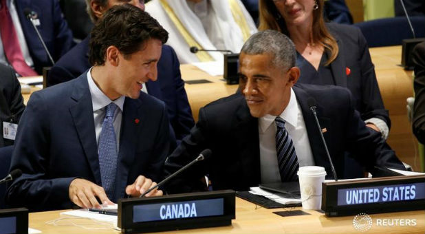 U.S. President Barack Obama talks with Canadian Prime Minister Justin Trudeau (L) at the Refugee Summit during the United Nations General Assembly