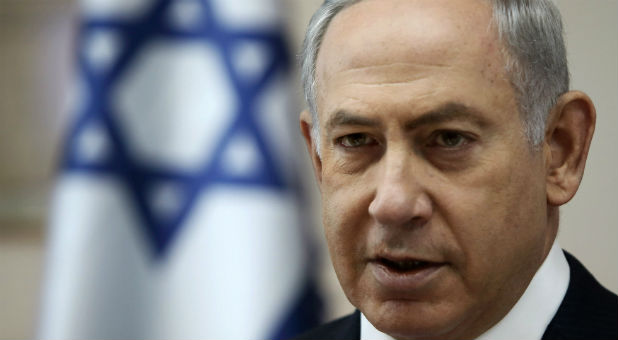 Israeli Prime Minister Benjamin Netanyahu opens the weekly cabinet meeting at his Jerusalem office moments after he was informed about a shooting attack in Jerusalem