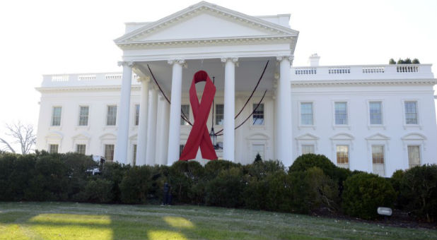 A giant red ribbon hangs from the North Portico of the White House to mark World AIDS Day.