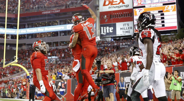 Tampa Bay Buccaneers wide receiver Mike Evans (13) celebrates with teammates after scoring a touchdown against the Atlanta Falcons during the first quarter at Raymond James Stadium.