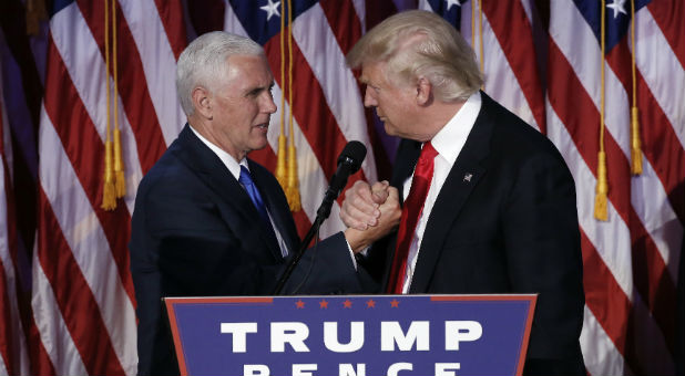 U.S. President-elect Donald Trump greets his running mate Mike Pence during his election night rally in Manhattan