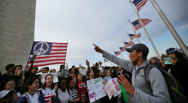 Students attend a protest against President-elect Donald Trump at the National Mall in Washington