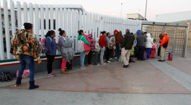 Immigrants from Central America and Mexican citizens, who are fleeing from violence and poverty, queue to cross into the U.S. to apply for asylum at the new border crossing of El Chaparral in Tijuana, Mexico.