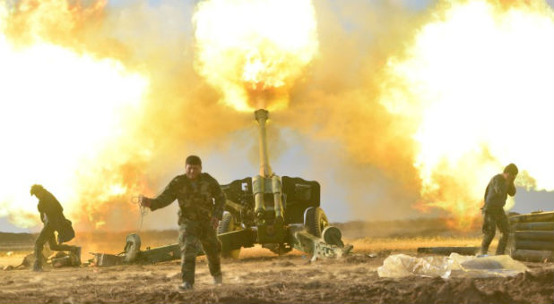 Members of Hashid Shaabi or Popular Mobilization Forces (PMF) fire toward Islamic State militant positions in west of Mosul, Iraq.