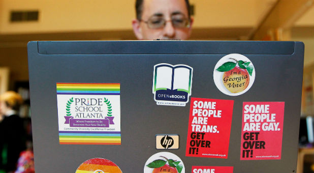 Director and Co-Founder Christian Zsilavetz, of the Pride School does work from his computer covered in stickers