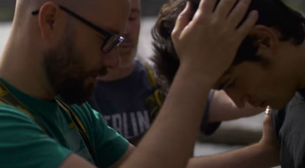 Missionaries baptize a refugee.