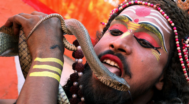A man dressed as Hindu Lord Shiva performs during a religious procession ahead of the Hindu festival of Maha Shivaratri