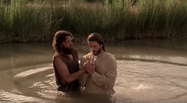 John the Baptist baptizes Jesus in the Jordan River.