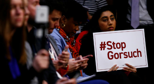 Attendees look on as Sen. Jeff Merkley, Sen. Mazie Hirono, Sen. Richard Blumenthal and Sen. Christopher Van Hollen hold a press conference in opposition of Supreme Court nominee Neil Gorsuch on Capitol Hill in Washington