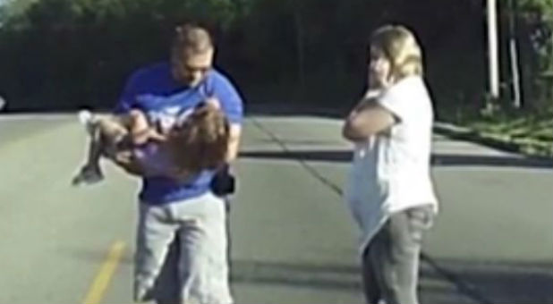 A trained emergency technician rescues a little girl who flew out of the back of a church bus.