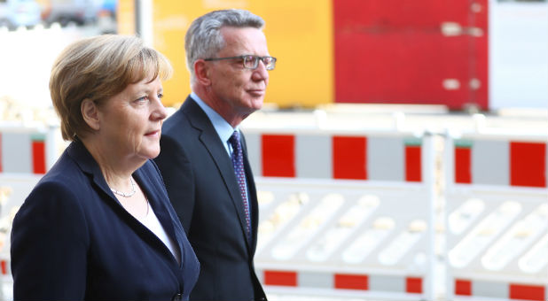 German Chancellor Angela Merkel and German Interior Minister Thomas de Maiziere arrive for a memorial service for the former Chancellor Helmut Kohl in Berlin, Germany, June 27, 2017.