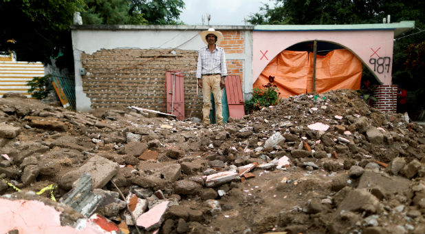 A man stands in the rubble after the Mexico earthquake.