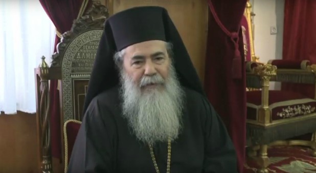 Hundreds of Palestinians blocked Patriarch Theophilos III's convoy as he drove to a church in Bethlehem to attend an Orthodox Christmas mass.